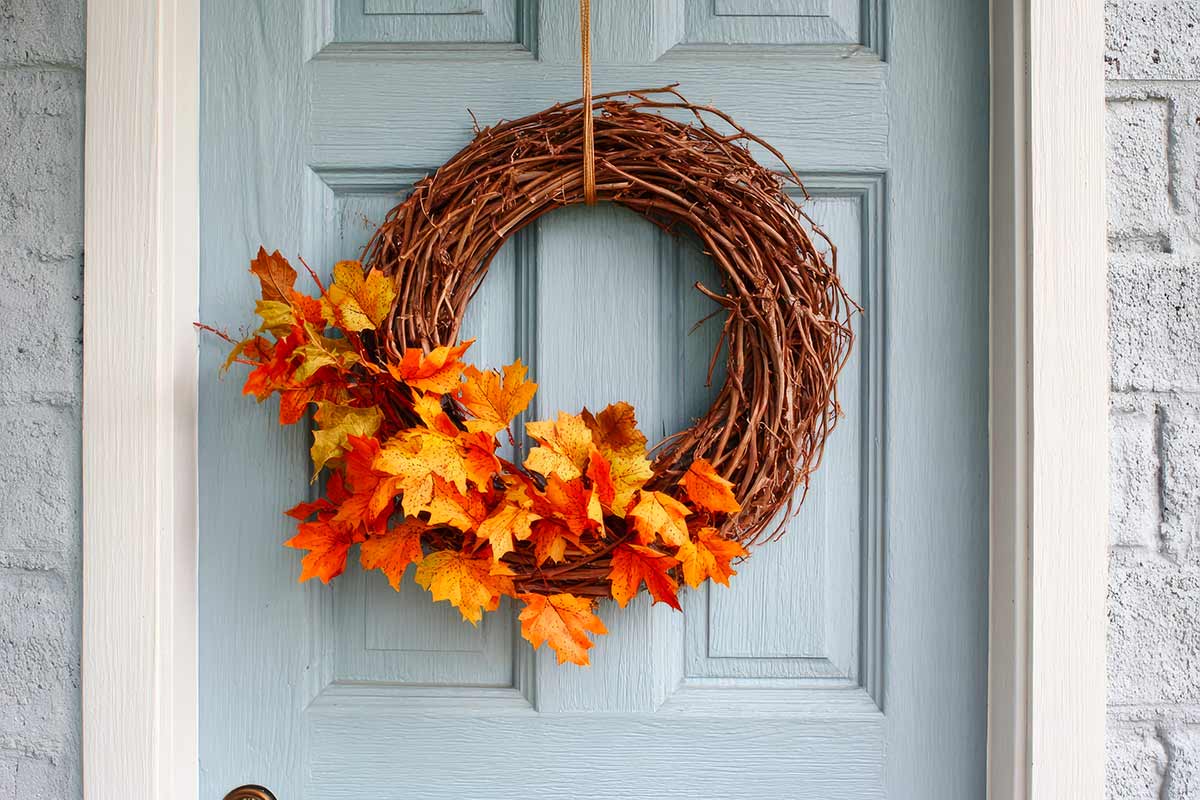 corona fuoriporta per l'autunno con rami secchi e foglie autunnali