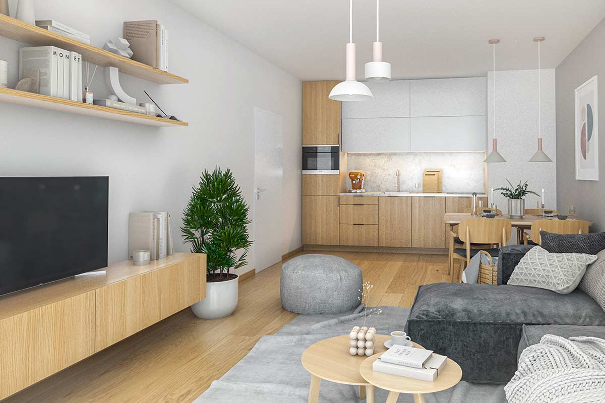 Soggiorno con mobili sospesi in legno chiaro, cucina open space, divano grigio e piante verdi. Ambiente ordinato e luminoso, arredato con soluzioni pratiche e materiali naturali.