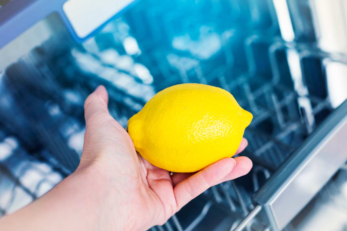 mezzo limone nel cestello delle posate della lavastoviglie